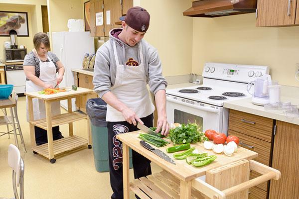 Students prepare food in the kitchen at the Burkhiser Technology Complex